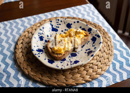 Scrambled eggs with toasted bread Stock Photo
