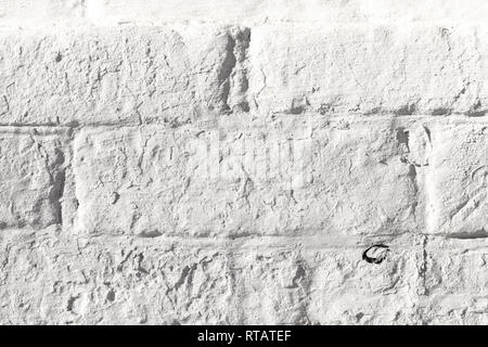 White painted old brick wall texture. Bleached rough aged brickwork. Niveous light background. Stock Photo