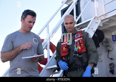 Petty Officer 2nd Class Lyman Dickinson and Petty Officer 3rd Class William Arrison, rescue swimmers at Coast Guard Sector San Diego, discuss procedure during a mass-casualty rescue exercise aboard Coast Guard Cutter Haddock at Sector San Diego Feb. 6, 2019. Mass-casualty rescue exercises allow responders to improve proficiency for difficult tasks in a safe environment. Stock Photo