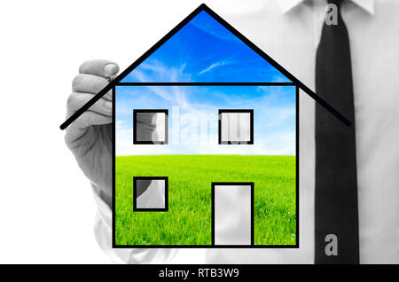Man drawing eco house on virtual screen. Stock Photo