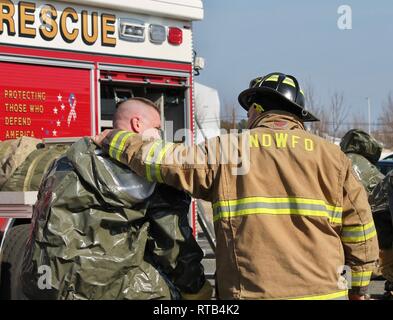 NAS PATUXENT RIVER, Maryland (Feb. 6, 2019) - Members of NAS Patuxent River's Fire Department have a moment of rest following a hazmat drill during the Citadel Shield/Solid Curtain 2019 exercise. Conducted by Commander, U.S. Fleet Forces Command and Commander, Navy Installations Command, the two-week, two-part exercise uses realistic drills and scenarios to enhance the readiness of Navy security forces and ensure seamless interoperability among the tenant commands, fire and medical services, and agency partners. Stock Photo