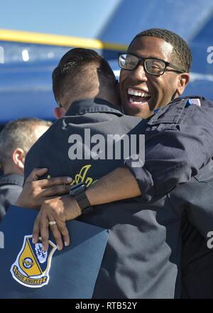 EL CENTRO, Calif. (Feb. 7, 2019)  Logistics Specialist 1st Class Vincent Smith, a native of Jacksonville, N.C., embraces his teammate after recieving his Blue Angels Crest. New Blue Angels must complete a three-month qualification process prior to wearing the crest of the U.S. Navy Flight Demonstration Squadron. The team is scheduled to conduct 61 flight demonstrations at 32 locations across the country to showcase the pride and professionalism of the U.S. Navy and Marine Corps to the American public. Stock Photo