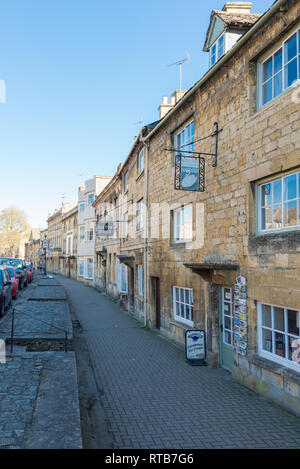 Row of shops on the terraced footpath in the pretty Cotswold market town of Chipping Campden, Gloucestershire Stock Photo