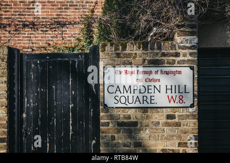 London, UK - February 23, 2019: Campden Hill Square street name sign on a brick wall in The Royal Borough of Kensington and Chelsea, an affluent area 
