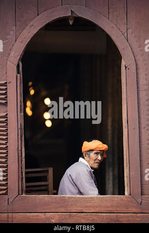 Portrait of a Burmese elder at a wooden window of the Shwe Yan Pyay Monastery in Nyaungshwe, Myanmar (Burma). Stock Photo