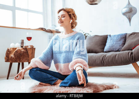 Beautiful nice woman practicing yoga at home Stock Photo