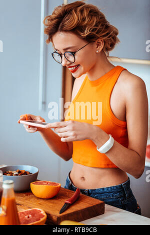 Nice happy woman taking photos of food Stock Photo