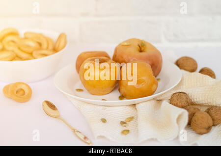 Baked apples on the plate, on white background. Still life concept. Stock Photo