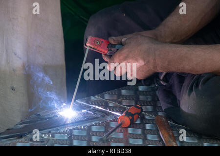 man using electric arc welder Stock Photo