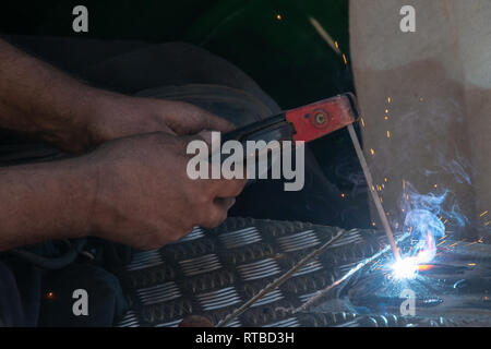 man using electric arc welder Stock Photo