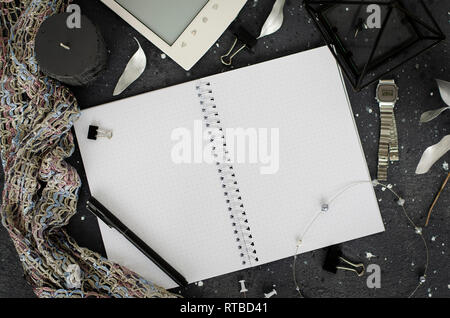 Decorated opened notebook with white sheets on dark background. Top view. Copy space Stock Photo