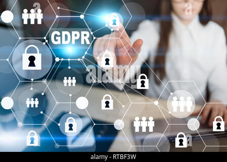 GDPR and cybersecurity. Business woman protecting data personal information on laptop. Padlock icon, people and internet technology networking connect Stock Photo