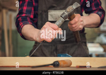 The worker makes measurements of a wooden board Stock Photo