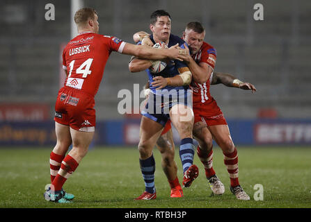 St Helens Saints' Louie McCarthy-Scarsbrook is tackled by Salford Red Devils' Joey Lussick (left), Junior Sa'u (centre) and Salford Red Devils' Josh Jones, during the Super League match at AJ Bell Stadium, Salford. Stock Photo