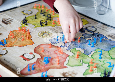 People playing the classic strategy baord game Risk Stock Photo