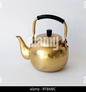 Beautiful golden vintage kettle isolated on white background Stock Photo