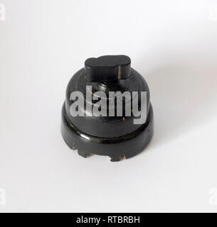 Old black bakelite switch, isolated with white background Stock Photo