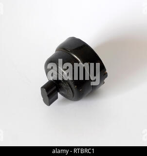 Old black bakelite switch, isolated with white background Stock Photo