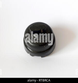 Old black bakelite switch, isolated with white background Stock Photo