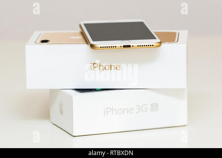 PARIS, FRANCE - SEP 26, 2016: New Apple iPhone 7 Plus next to old vintage iPhone 3GS box  Stock Photo