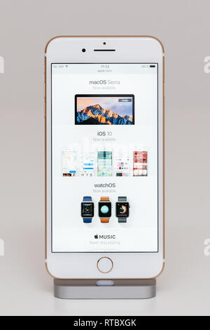 PARIS, FRANCE - SEP 26, 2016: New Apple iPhone 7 Plus in docking station after unboxing and testing by installing and running the Apple Website with Macos Sierra now awailable and apple watch available  Stock Photo