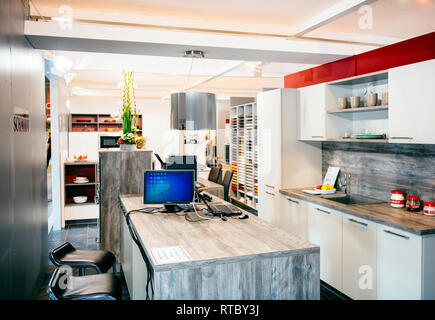 PARIS, FRANCE - SEP 5, 2014: Interior of kitchen store seen from the street with diverse samples of the wood and MDF - cusine Schmidt Stock Photo