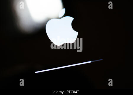 PARIS, FRANCE - SEP 12, 2014: Apple Computers logotype onthe retina screen display of the latest iPad tablet  displaying progess update loading bar Stock Photo
