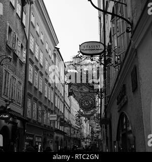 Black and white vintage store signs on Getreidegasse, the shopping street of Salzburg, Austria Stock Photo