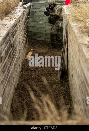 An infantryman from the 2nd Armored Brigade Comba Team, 1st Cavalry Division enters and clears a trench during the combined arms live-fire exercise (CALFEX) Feb. 9. Stock Photo