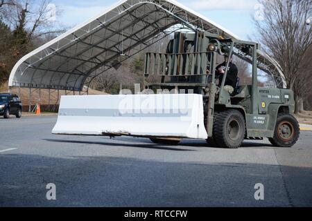 NAS PATUXENT RIVER, Maryland (Feb. 13, 2019) - Master-at-Arms 3rd Class Timothy Minyard mans a forklift to move concrete barriers for a gate closure drill during the Citadel Shield/Solid Curtain 2019 exercise. Conducted by Commander, U.S. Fleet Forces Command and Commander, Navy Installations Command, the two-week, two-part exercise uses realistic drills and scenarios to enhance the readiness of Navy security forces and ensure seamless interoperability among the tenant commands, fire and medical services, and agency partners. Stock Photo