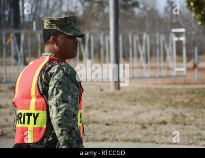 NAS PATUXENT RIVER, Maryland (Feb. 13, 2019) - Boatswain's Mate 1st Class Michael Sutton directs traffic for a gate closure drill during the Citadel Shield/Solid Curtain 2019 exercise. Conducted by Commander, U.S. Fleet Forces Command and Commander, Navy Installations Command, the two-week, two-part exercise uses realistic drills and scenarios to enhance the readiness of Navy security forces and ensure seamless interoperability among the tenant commands, fire and medical services, and agency partners. Stock Photo