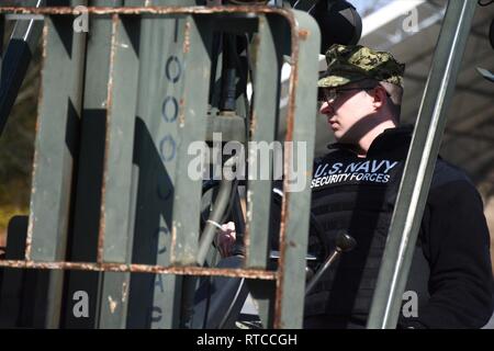 NAS PATUXENT RIVER, Maryland (Feb. 13, 2019) - Master-at-Arms 3rd Class Timothy Minyard mans a forklift to move concrete barriers for a gate closure drill during the Citadel Shield/Solid Curtain 2019 exercise. Conducted by Commander, U.S. Fleet Forces Command and Commander, Navy Installations Command, the two-week, two-part exercise uses realistic drills and scenarios to enhance the readiness of Navy security forces and ensure seamless interoperability among the tenant commands, fire and medical services, and agency partners. Stock Photo