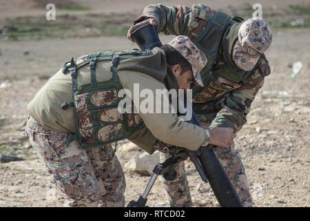 Soldiers with the Jordan Armed Forces’ 10th Border Guard Force prepare an M252 81 mm mortar system for a joint-training exercise with the California National Guard’s 1st Squadron, 18th Cavalry Regiment at a range outside of Amman, Jordan on Feb. 13, 2019. The 10th BGF continues to train alongside their U.S. Army counterparts as part of the Jordan Operational Engagement Program, solidifying an ongoing and strong partnership of mutual objectives and meeting common security challenges. Stock Photo