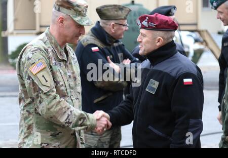 Col. Patrick Michaelis, commander of the Mission Command Element in Poznan, Poland, shakes hands with Maj. Gen. Adam Joks, Deputy Chief of the General Staff of the Polish Armed Forces, at the MCE Feb. 14.    The purpose of the visit was to gain an understanding of the MCE's command post daily operations.    U.S. forces deployed to Europe in support of Atlantic Resolve is evidence of the strong and unremitting U.S. commitment to NATO and Europe. Through continuous, multinational training and security cooperation activities, Atlantic Resolve builds readiness, increases interoperability and enhan Stock Photo