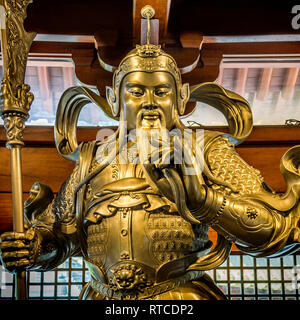 A gilded statue in the Jing'an Temple. A Buddhist temple on the West Nanjing Road in the Jing'an District of Shanghai, China. Stock Photo