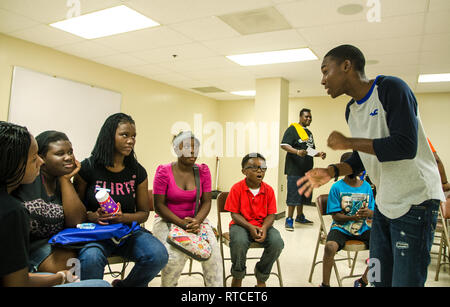 A high school senior talks to students in the Young People's Project about how the program has changed his life in Jackson, Mississippi. Stock Photo