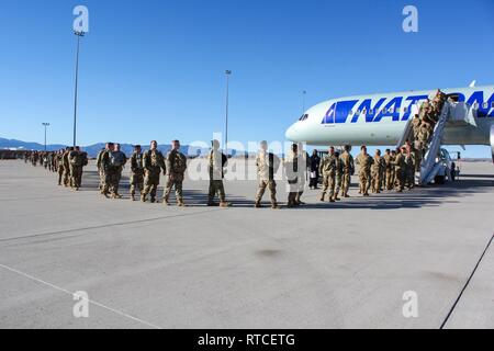 U.S. Army Soldiers assigned to Alpha Company, 52nd Brigade Engineer Battalion, 2nd Infantry Brigade Combat Team, 4th Infantry Division, border an aircraft, Feb. 15, 2019, as prepare to depart to provide military support to the Department of Homeland Security and U.S. Customs and Border Protection to secure the southwest border of the United States. Stock Photo