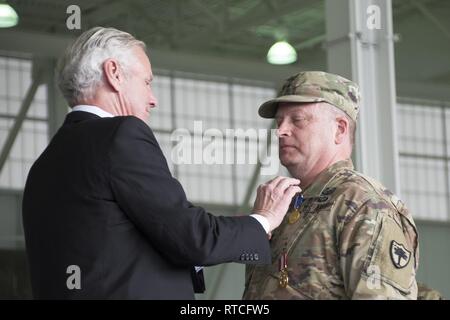 South Carolina Gov. Henry McMaster awarded Adjutant General, U.S. Army Maj. Gen. Robert E. Livingston, Jr., the outgoing adjutant general, with the South Carolina Guardsman Retirement Medal during a change of command ceremony at McEntire Joint National Guard Base in Eastover, South Carolina, Feb. 16, 2019. The ceremony welcomed U.S. Army Maj. Gen. Van McCarty as the 29th adjutant general of South Carolina and the first to be selected by the governor rather than elected. Stock Photo