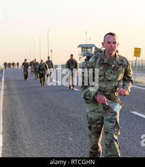 U.S. Army Sgt. 1st Class David Moseley, 335th Signal Command (Theater) (Provisional), marches during the Presidents Day 10K Ruck Sack March at Camp Arifjan, Kuwait, Feb. 18, 2019. Moseley finished the ruck march in 1:10:58. The event is in line with the Army's modernization strategy to make Soldiers and units more lethal to win our nation's wars, them come home safely. Stock Photo