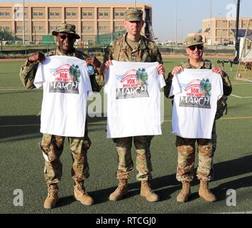 U.S. Army Soldiers assigned to the 335th Signal Command (Theater) (Provisional) pose for a group photo after completing the Presidents Day 10K Ruck Sack March at Camp Arifjan, Kuwait, Feb. 18, 2019. Pictured from left to right are: Master Sgt. James Geter, Sgt. 1st Class David Moseley, Chaplain (LTC) Carlos-Correa-Oquenda. The event is held in honor of George Washington, the first President of the United States. The event is in line with the Army's modernization strategy to make Soldiers and units more lethal to win our nation's wars, them come home safely. Stock Photo