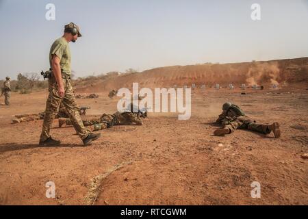 A Czech Special Forces Soldier observes Malian soldiers as they fire their AK-47 rifles near base camp Loumbila, in Burkina Faso on Feb. 19, 2019. The training event is part of exercise Flintlock 2019 and enhances the Malian Soldiers proficiency with their weapons and battle movements. Flintlock is U.S. Africa Command's premier special operations forces exercise in Africa. Stock Photo