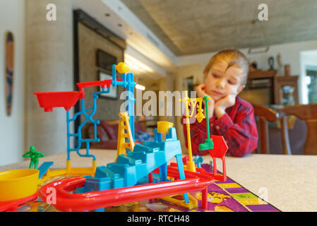 A six year old boy playing Mouse Trap board game Stock Photo