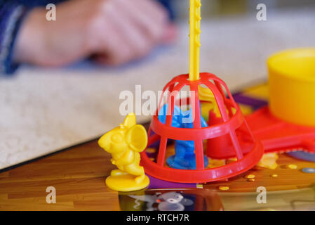 Trapped mouse playing piece in the Mouse Trap board game Stock Photo