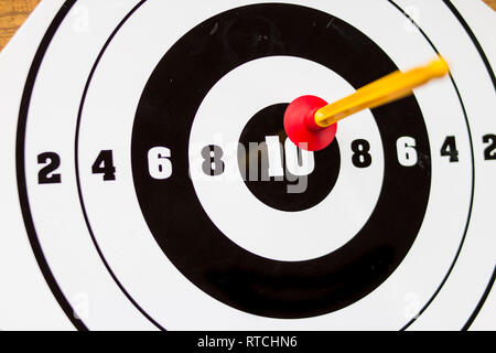 Playing toy darts. Kids game.The concept of setting targets and trying to reach them. Closeup.success ,winner and loser concept, selective focus Stock Photo