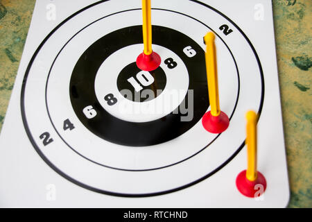 Playing toy darts. Kids game.The concept of setting targets and trying to reach them. Closeup.success ,winner and loser concept, selective focus Stock Photo