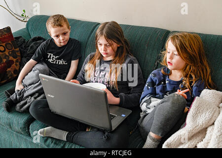 children watching video on laptop Stock Photo