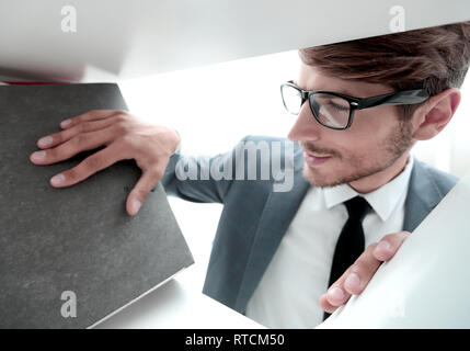 smiling man looking at documents Stock Photo