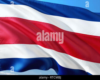 Flag of Costa Rica waving in the wind against deep blue sky. High quality fabric. Stock Photo