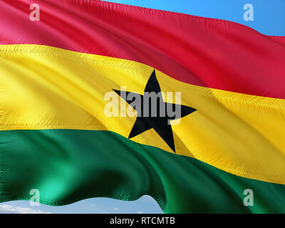 Flag of Ghana waving in the wind against deep blue sky. High quality fabric. Stock Photo