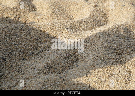 Sand surface background on the beach. Small sand stone of sand wall texture or sand wall background Stock Photo